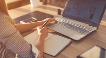 Female sat at desk on laptop studying
